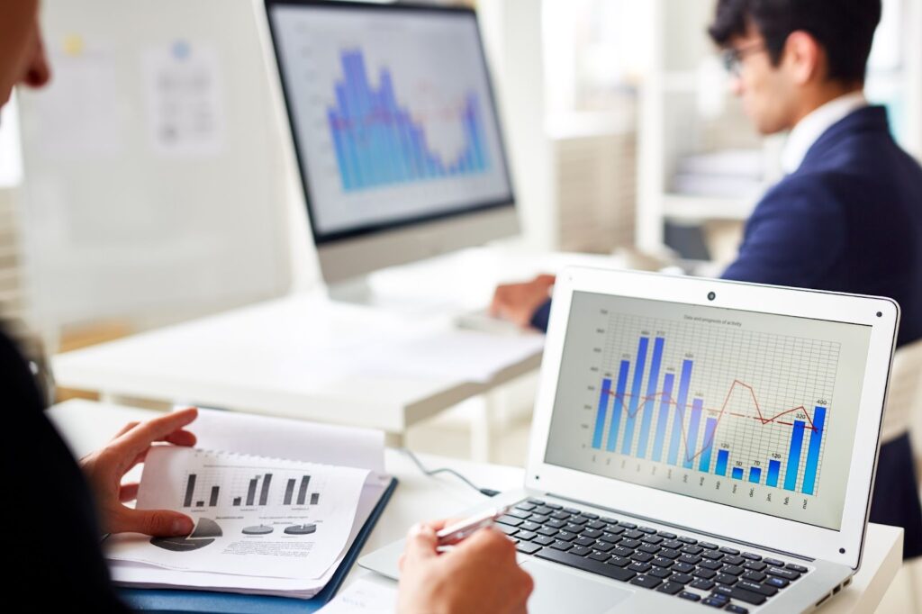 Woman looking on graphs and taking notes